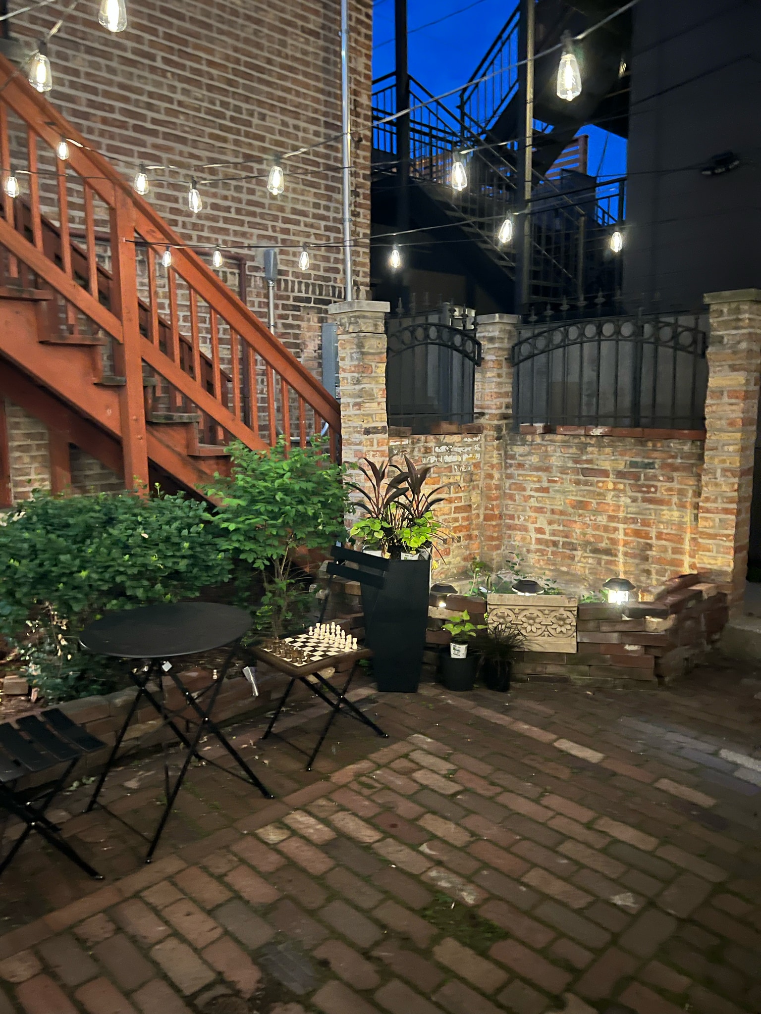 nighttime view of courtyard from different angle with a chess set! - 2446 W Thomas St