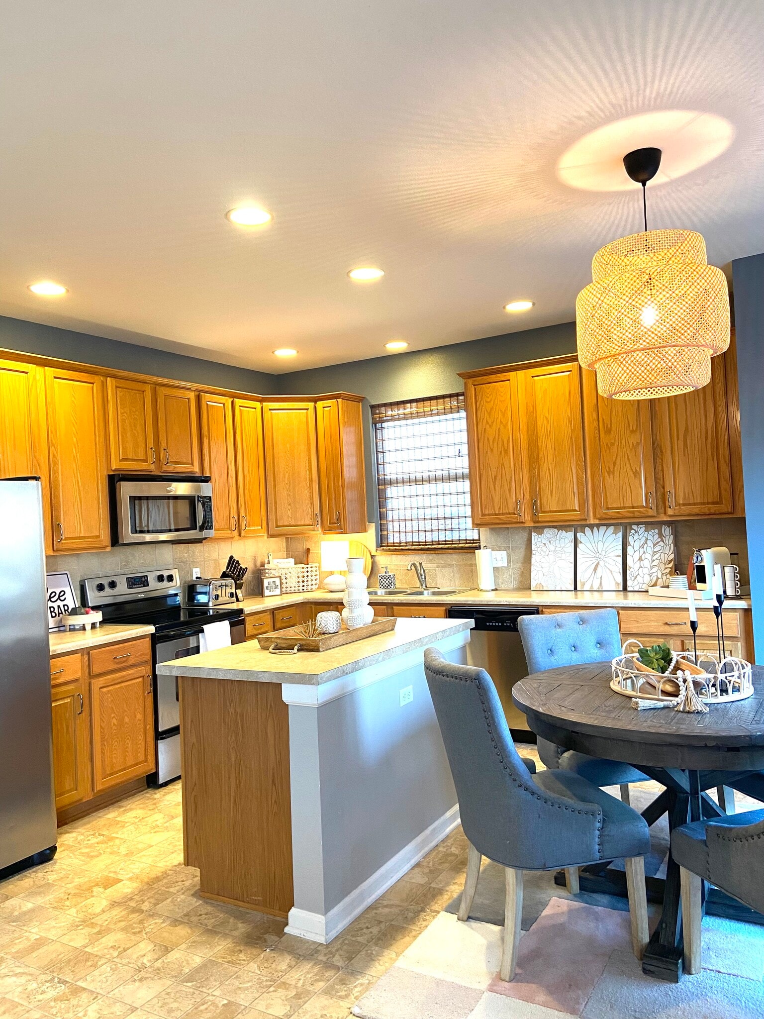 Kitchen with stainless steel appliances - open to family room - 1207 N 207th Cir
