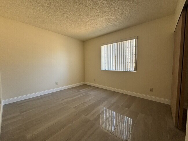 Building Photo - Downstairs 2BR/1BA—recently updated with new flooring, new countertops, and clean, neutral finishes.
