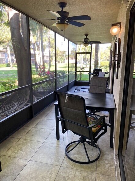 Large screened patio with sliders from living room and both bedrooms, furnished with table, chairs - 123 Deer Creek Blvd
