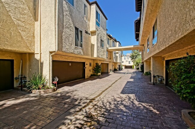 Building Photo - BRIGHT & AIRY, REAR-UNIT TOWNHOUSE W/ SPACIOUS PATIO, BALCONY & HUGE 2-CAR GARAGE IN GATED COMMUN...