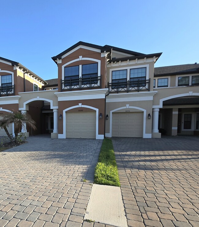 Large pavered driveway and one car garage. - 30149 Southwell Ln