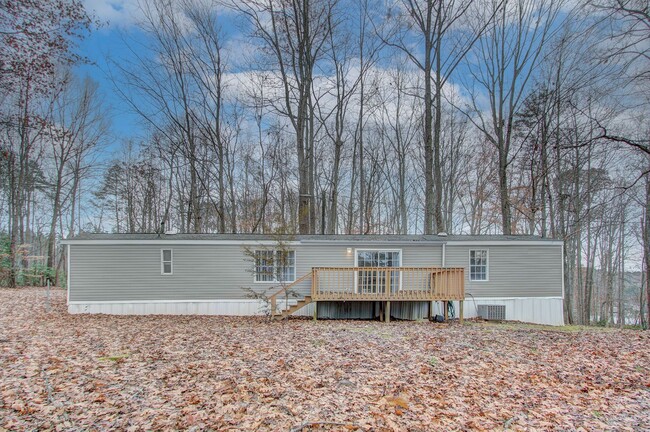 Building Photo - Nestled on a spacious, private wooded wate...