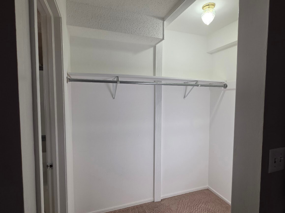 Primary bedroom has walk-in closet with floor to ceiling lighting - 4104 Kim Dr