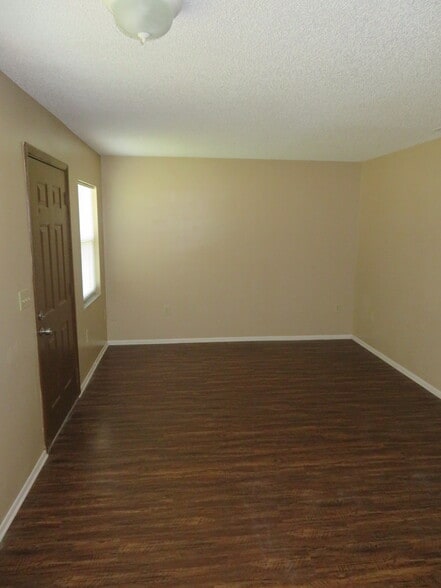 Living room with vinyl plank flooring. - 2418 S San Gully Rd