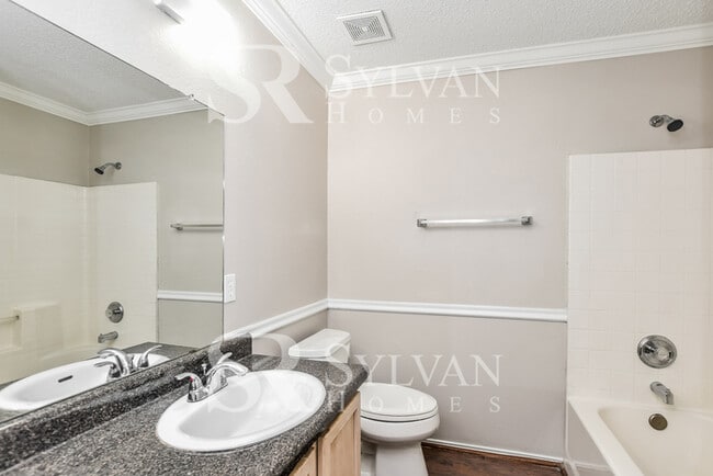 Building Photo - The living is easy in this gorgeous 4BR, 2.5BA brick home