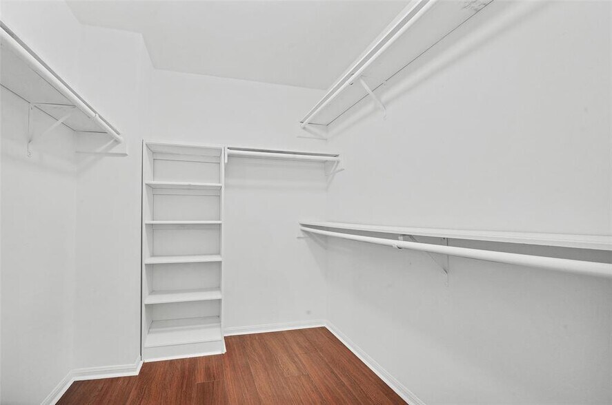 Primary bedroom walk-in closet with storage space, and built-in shoe rack - 5703 Green Timbers Dr