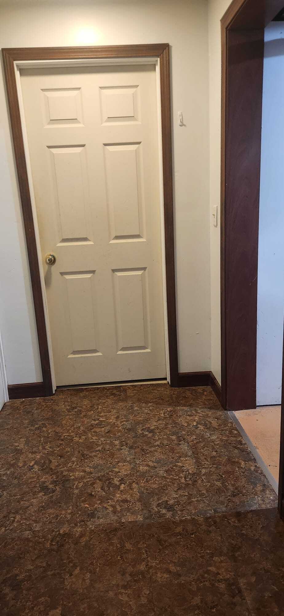 Door to downstairs apartment with door closed and view of bedroom door - 2116 Thaler Ave