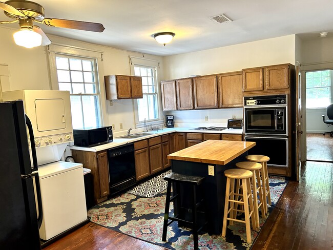 Large kitchen has been updated with new range, microwave hoodvent & coffee station - 2427 Calhoun St