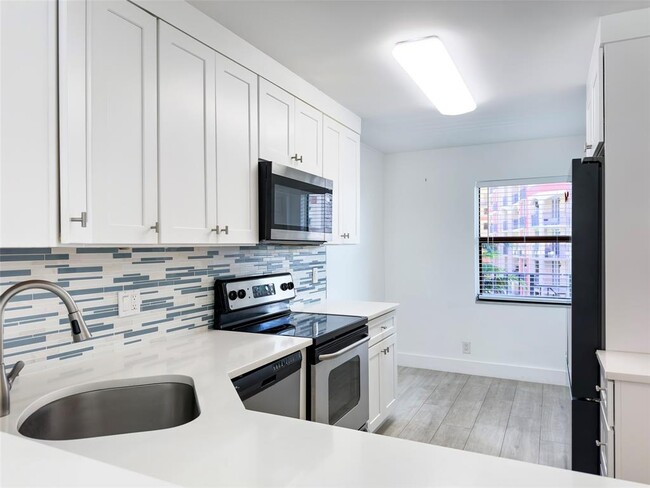 Cook and entertain in the updated kitchen with view out through multiple windows. - 2029 N Ocean Blvd