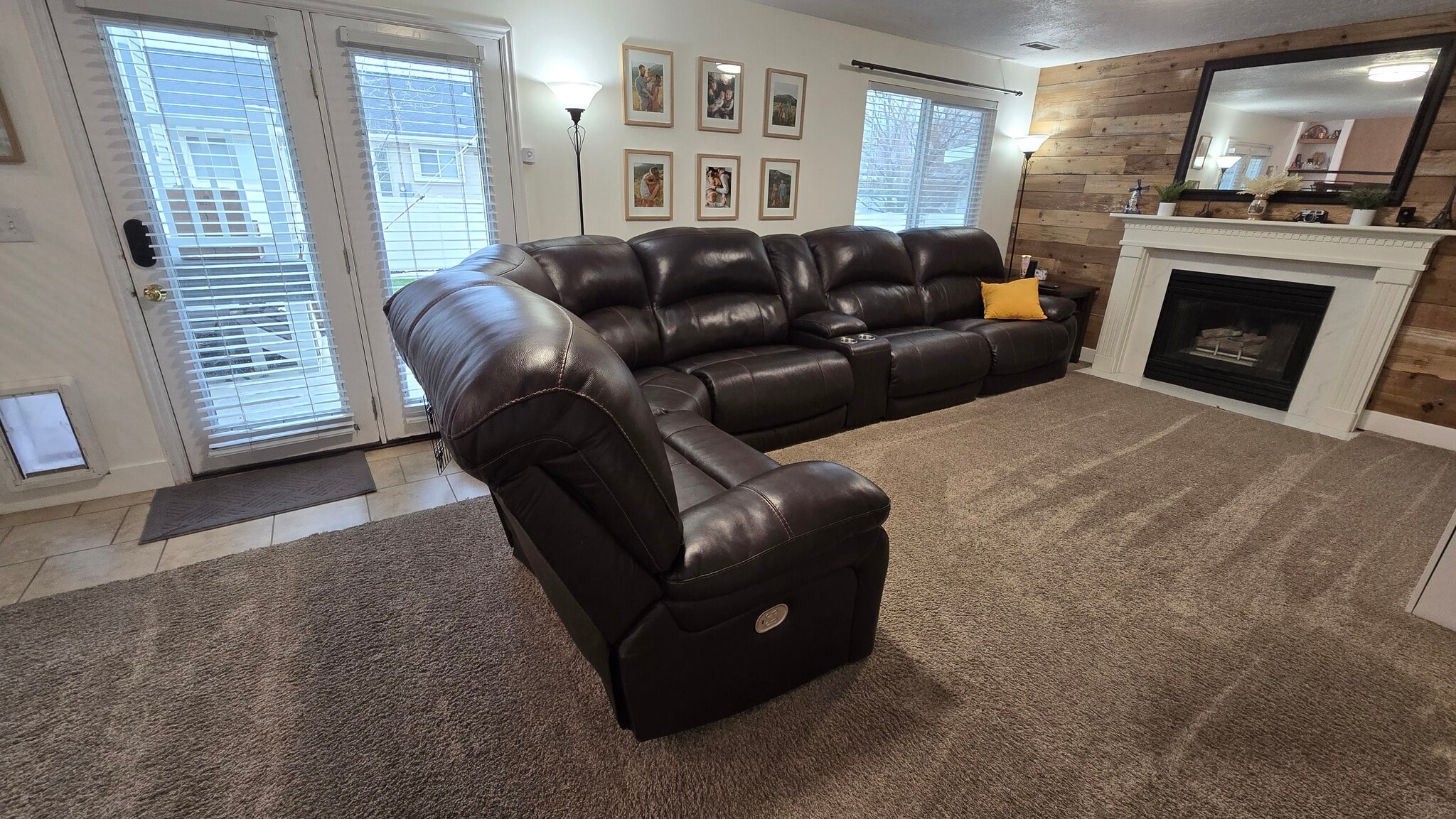Living room with built-in storage, fireplace and pet door - 2504 W Pine Needle Pl