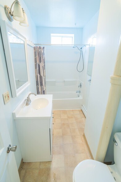 Bathroom with tub and shower - 100 N Main St