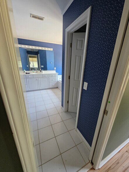His and her walk-in closests. Tub, and shower. - 8803 Whaley Cir