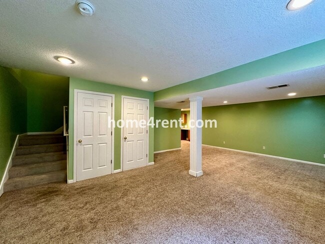 Building Photo - Beautiful Four-Bedroom Home with Three Car Garage, Wood Floors, Finished Basement and a Fenced Ya...