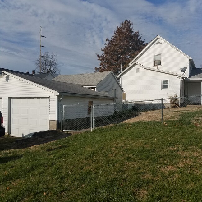 Fenced backyard, garage, workshop, and house - 1201 E Walnut St