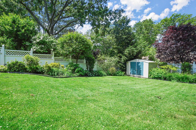 Large yard with mature plantings. - 319 Davenport Ave