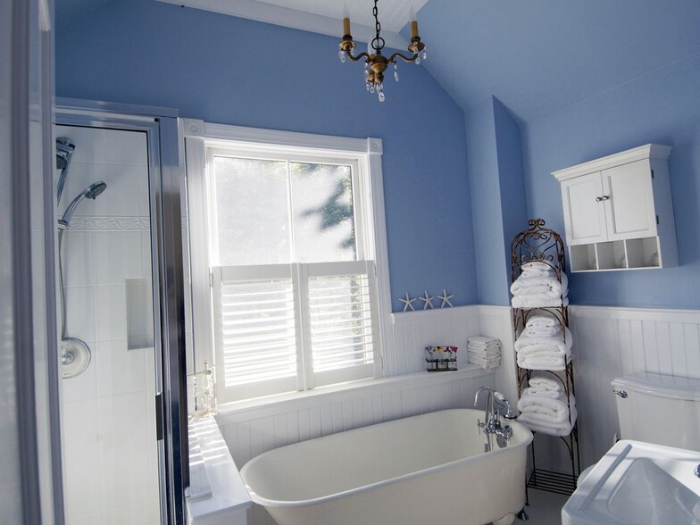 The beautiful upstairs bath with the original clawfoot tub and a glass shower. - 23 Graffam Rd