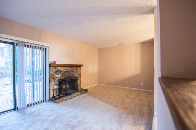 Living Room With Stone Fireplace and Sliding Doors to huge private deck - 115 Beechnut St