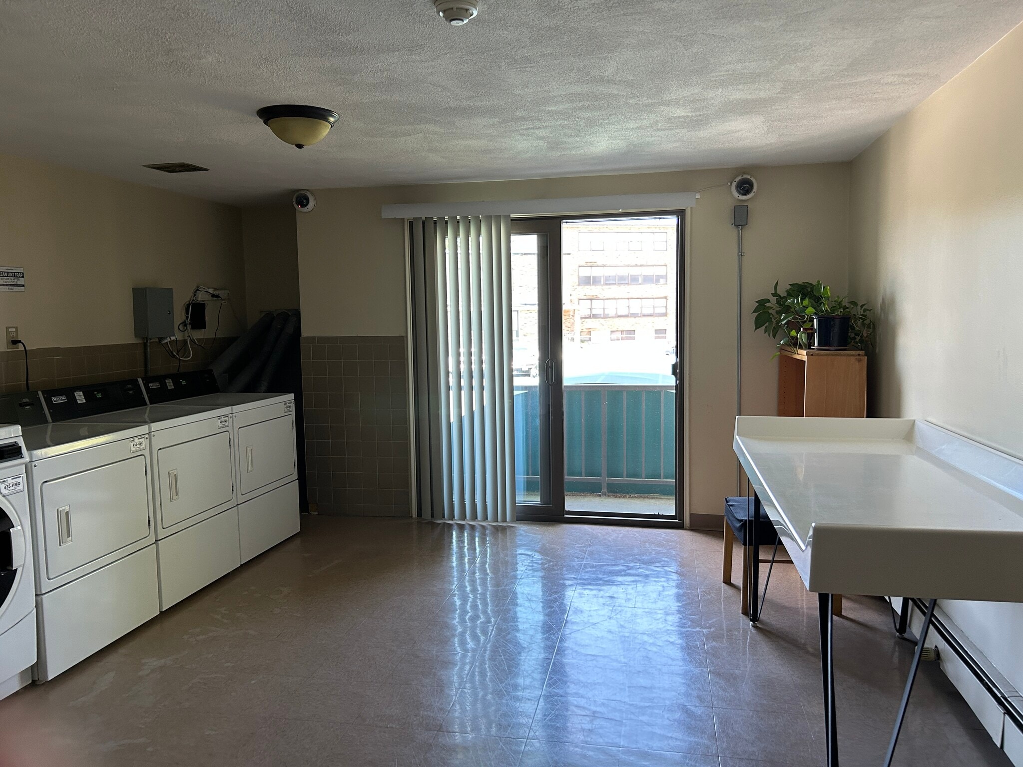 Laundry Room with Balcony, Folding Table, and Cameras - 29 Harvard Ave