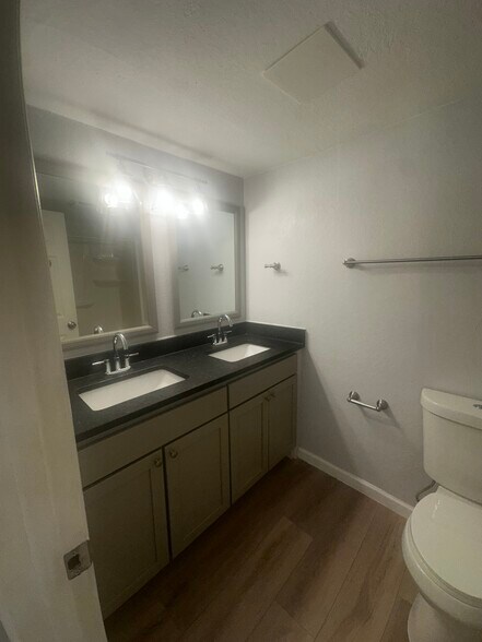 Modern double vanity with granite countertop. - 12170 Huron St