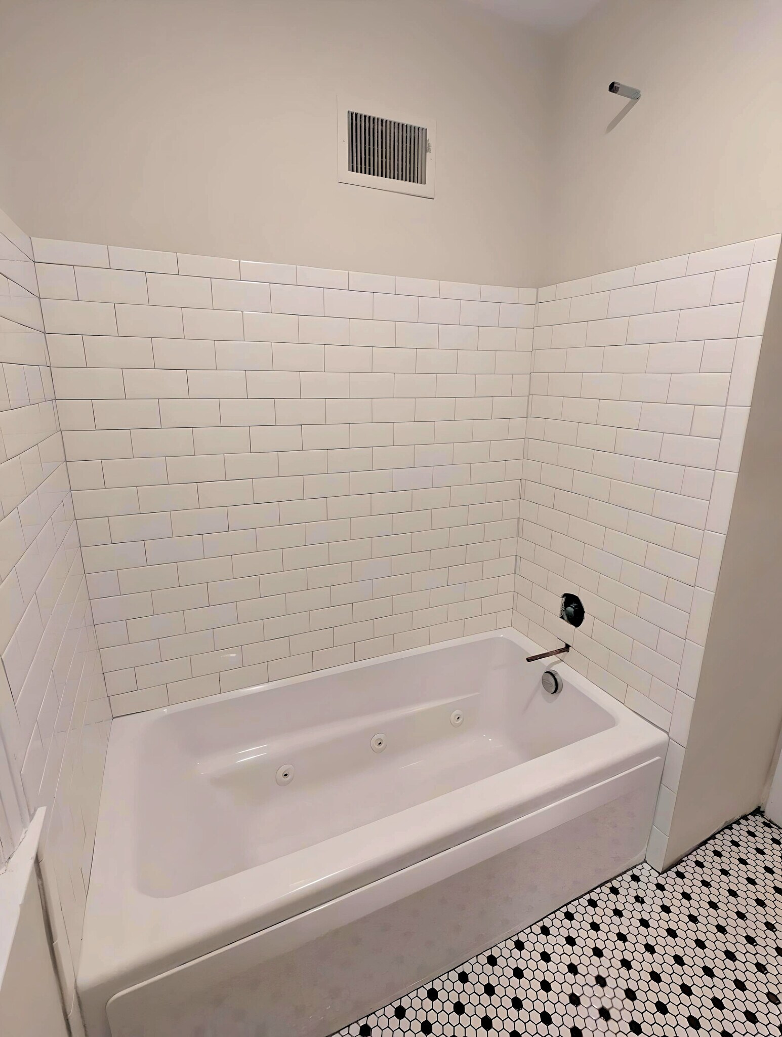 Renovated shower/tub with new tile. Black fixtures to be added before move-in. - 2734 N Avondale Blvd