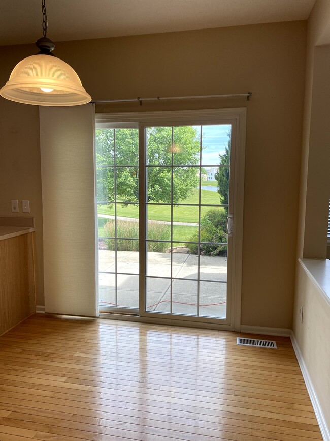 Sliding glass door leading to backyard with walking trail access - 14295 Chariots Whisper Dr