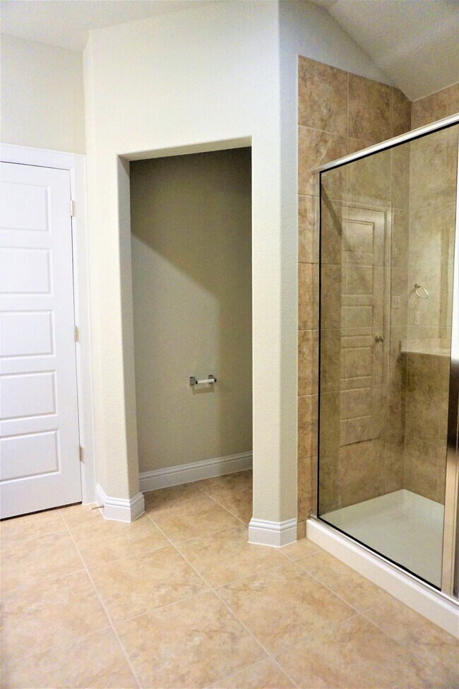 Primary bathroom features double granite top vanities & upgraded walk-in shower - 260 Gaida Loop
