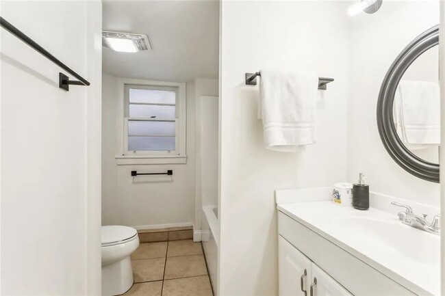 Bathroom 1 with a tub/shower and vanity area - 5830 S Robertson St