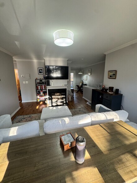 Living area w wood burning fireplace, TV mounting area and space for table/desk - 2841 S Wakefield St