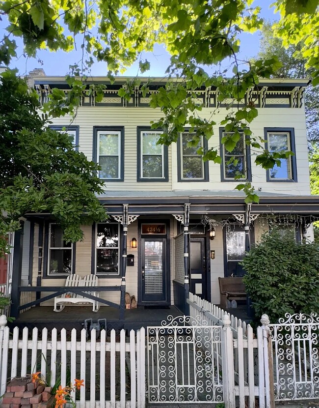 Charming front view of home featuring a relaxing porch with rocking chair. - 424 1/2 S Pine St