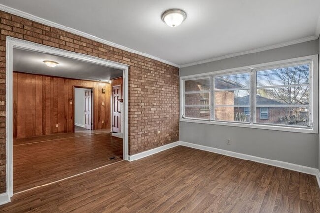 Building Photo - Large Brick Ranch, New Wood Like Flooring Throughout, Just Painted, LR, Den, Sun Room, Carport!