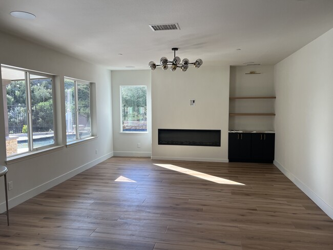 Family room with space for HUGE television, large electric fireplace and open shelving - 34189 Hourglass St