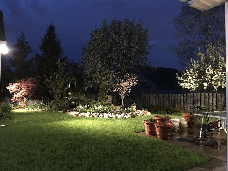 Patio View of Lighted Backyard Garden - 236 Crabapple Ln