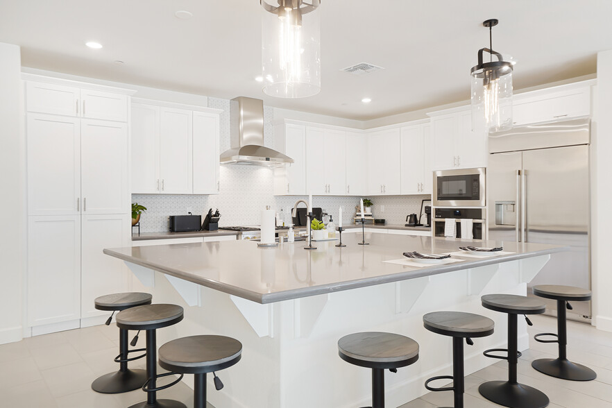 Chef’s kitchen w/ walk-in pantry, Wolf fridge, double oven, microwave & dishwasher. - 5919 Lakestone Dr