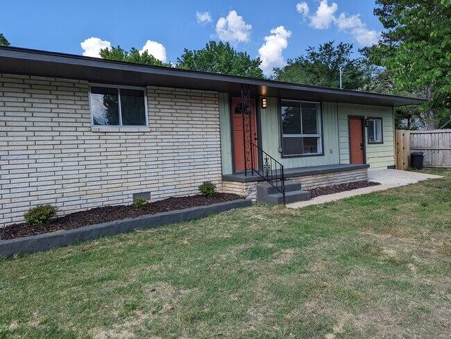 Classic linear mid-century ranch appeal, with a deep soffit covering the porch. - 2008 E Huntsville Rd