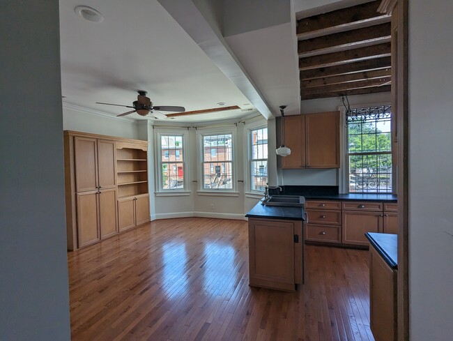 the open living room and kitchen with built-in bookcases - 4413 GEORGIA AVE NW
