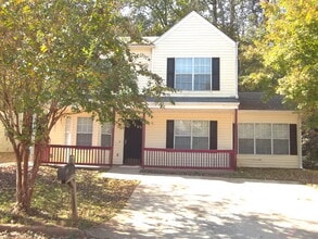 Building Photo - Freshly painted and new flooring in this 4 Bedroom 2 and Half Bath home. Covered front porch with...