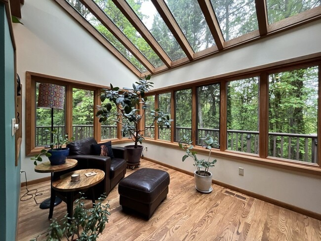 Building Photo - One-of-a-Kind Custom Home with Wall of Windows, Stone Fireplaces, Expansive Entertainment Space &...