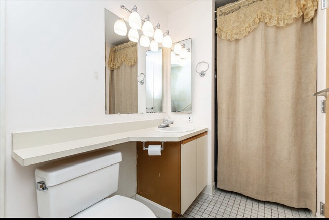 Main Bathroom with in unit Washer and Dryer behind curtain - 150 Lynnway