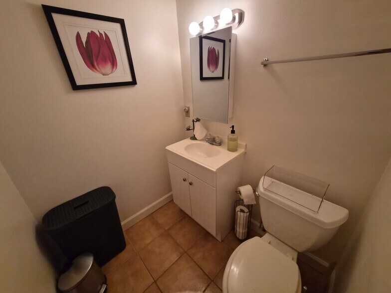 Private bathroom with cabinet, hamper and vanity. - 7 Canterbury Ct SE