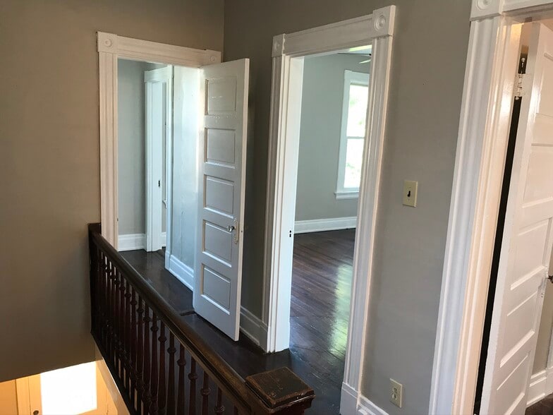 Landing with natural woods staircase. - 2221 Oakland Ave