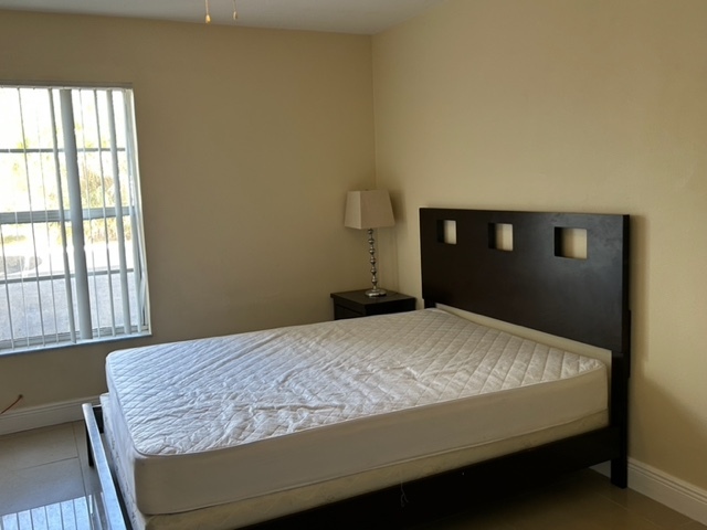 furnished bedroom with queen bed - 490 NW 20th St