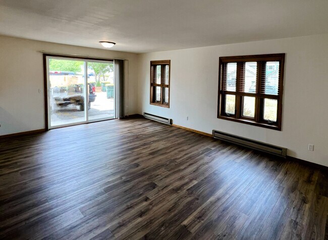 open-concept living and dining area with large windows bringing in plenty of natural light - 213 Ash Street