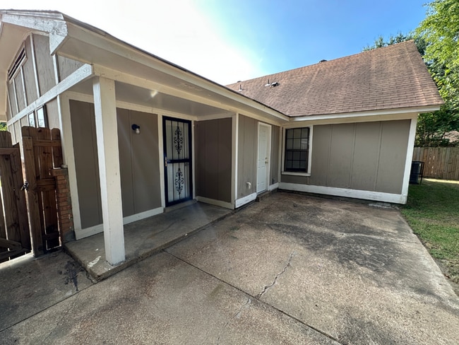 Building Photo - Charming 3BR/2BA Near Southwind | Soaring Vaulted Ceilings, Brick Fireplace & Fenced Yard