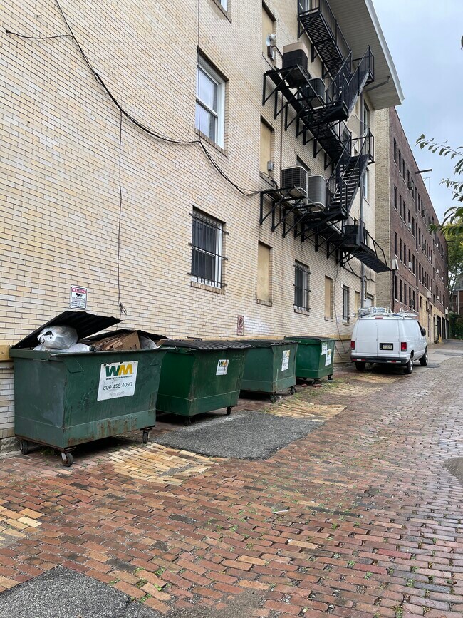 3 trash dumpsters, 1 recycling dumpster behind building - 5523 Ellsworth Ave