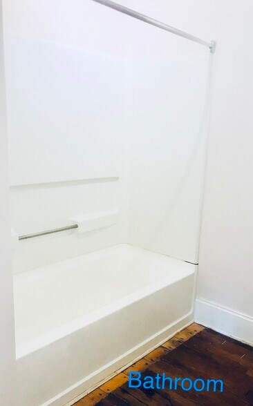 Full bathroom with tub, curved glass enclosure, and plenty of built-in storage space. - 1937 Fairfield Dr