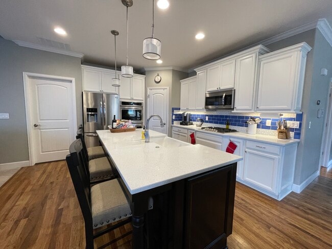 Large island with farmhouse sink, pantry, and double convections ovens - 1410 Promontory Bluff Vw