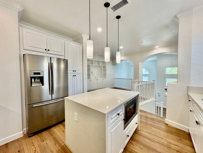 Building Photo - Beautifully Remodel Townhouse with AC & Two Car Garage!