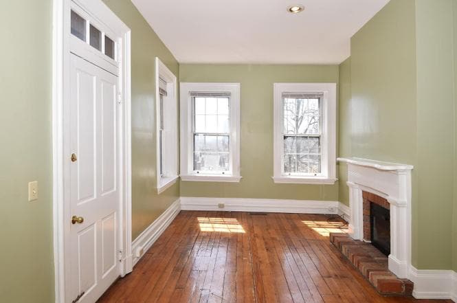 Original hardwood floors. Fireplace is inoperable but has a decorative space heater mounted in place. - 505 Milton St
