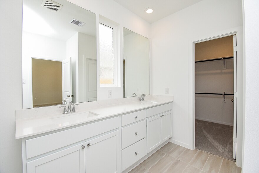 Primary bathroom and closet - 6714 Iron Clover Dr